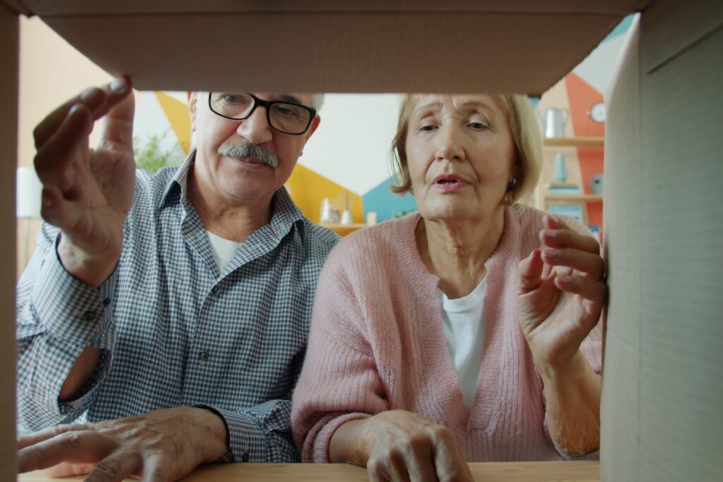 Older couple packing boxes while downsizing from their longtime Long Island home