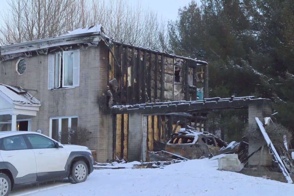 Charred, smoke damaged house after a fire, sold as-is for cash on Long Island