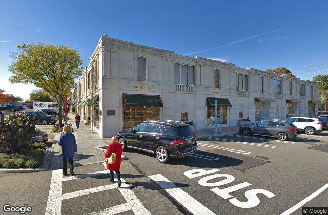 Street view of the Americana shopping district in Manhasset NY where EZ Home Buyers pays cash for houses