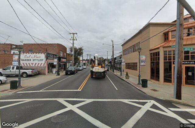 Street view of Rockaway Avenue village center in Valley Stream NY where EZ Home Buyers pays cash for houses