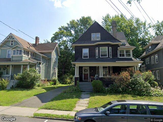 A shingled Victorian with a full front porch on Whitney Street in Hartford's West End