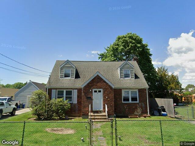 We buy houses in New Hyde Park, NY A brick Cape Cod with dormers on 2nd Avenue in New Hyde Park