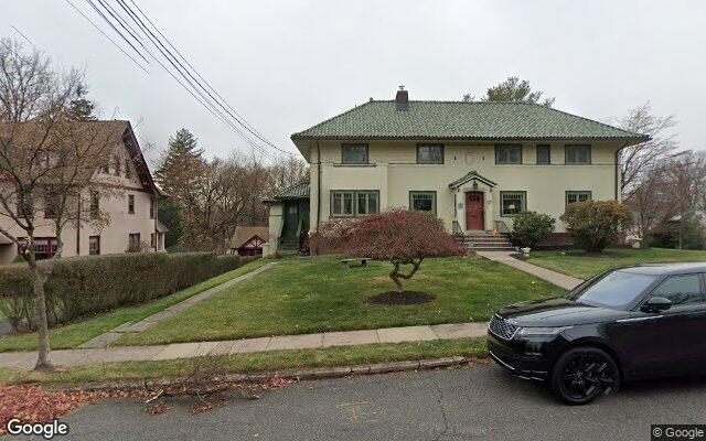 We buy houses in Plainfield, NJ A large stucco house on Hillside Avenue in Plainfield