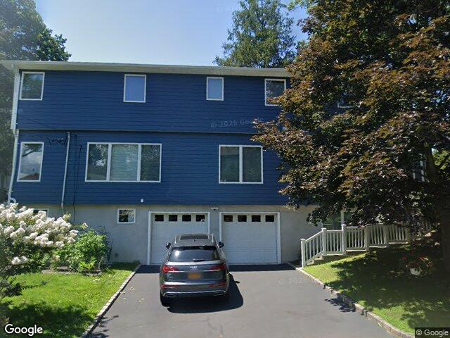 A two story colonial with garages under on Radcliff Avenue in Port Washington