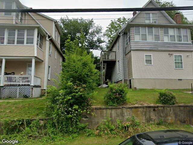 Older frame houses on a hillside along Kneen Street in downtown Shelton