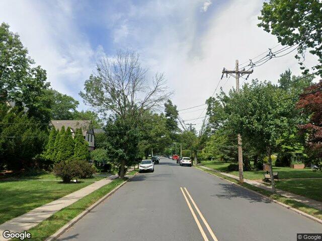 Tudor and colonial homes under mature trees on Standish Road in Teaneck, NJ