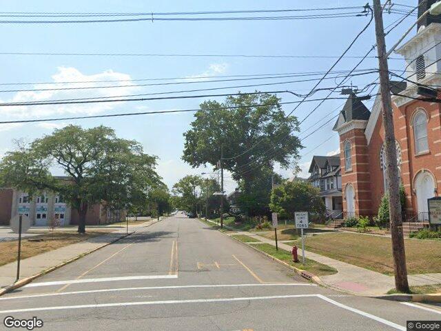 We buy houses in Woodbridge, NJ Brick church and tree lined block on Barron Avenue in Woodbridge, NJ