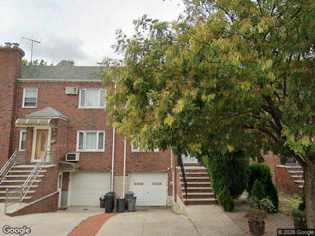 We buy houses in Middle Village, NY A semi attached brick house with a built in garage near Juniper Valley Park in Middle Village, Queens